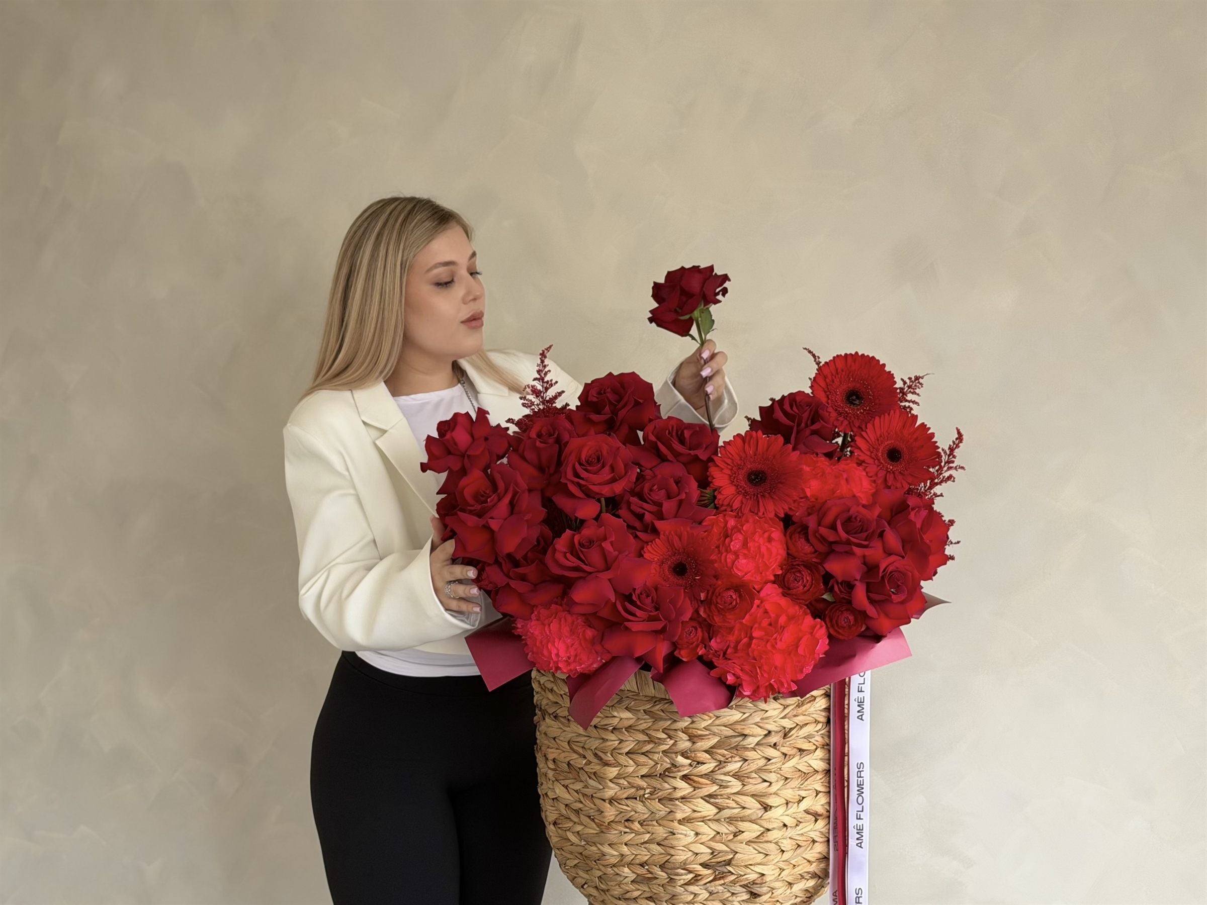 Red rose arrangement in a woven basket
